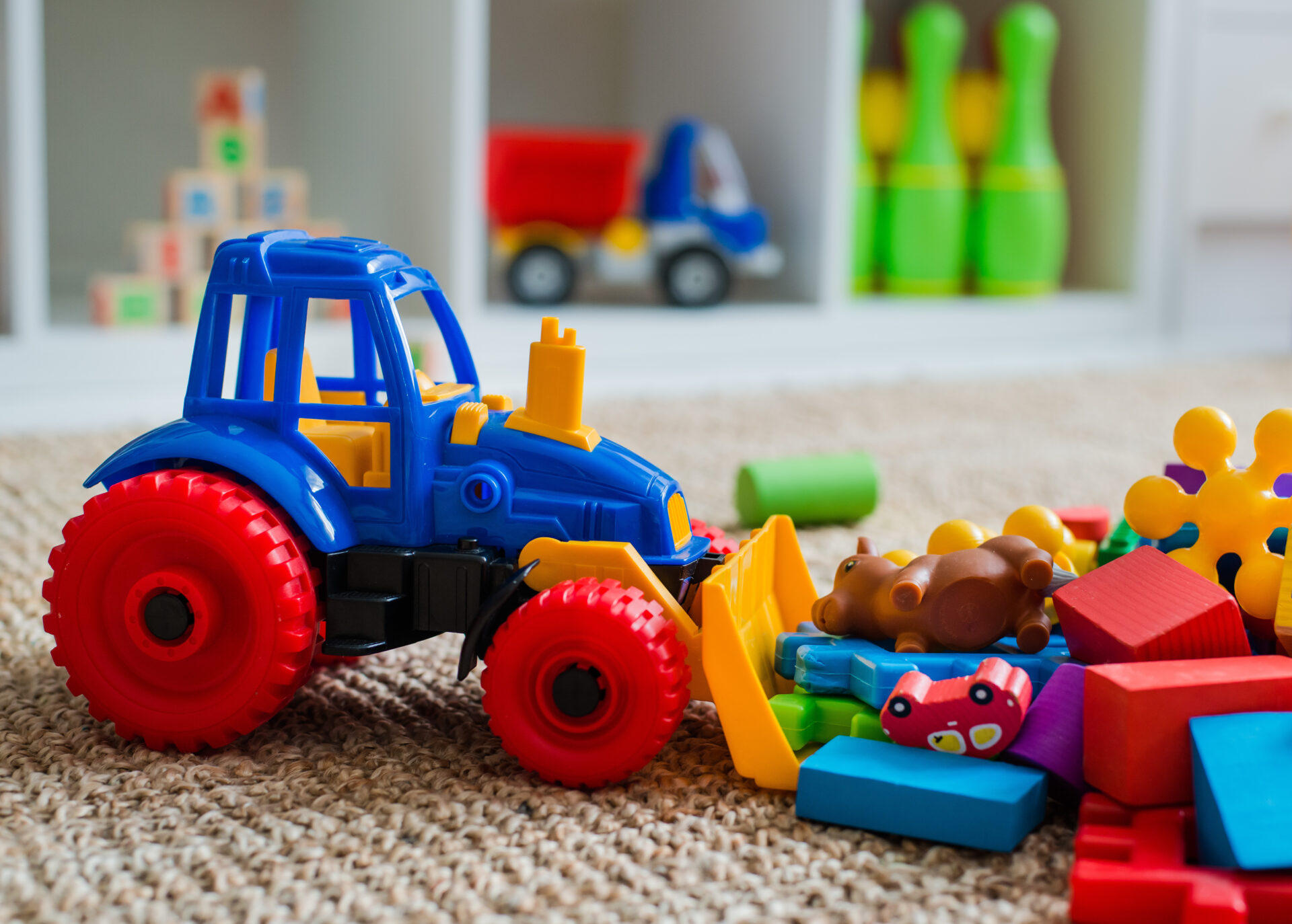 Children's playroom with plastic colorful educational blocks toys. Games floor for preschoolers kindergarten. interior children's room. Free space. background mock up